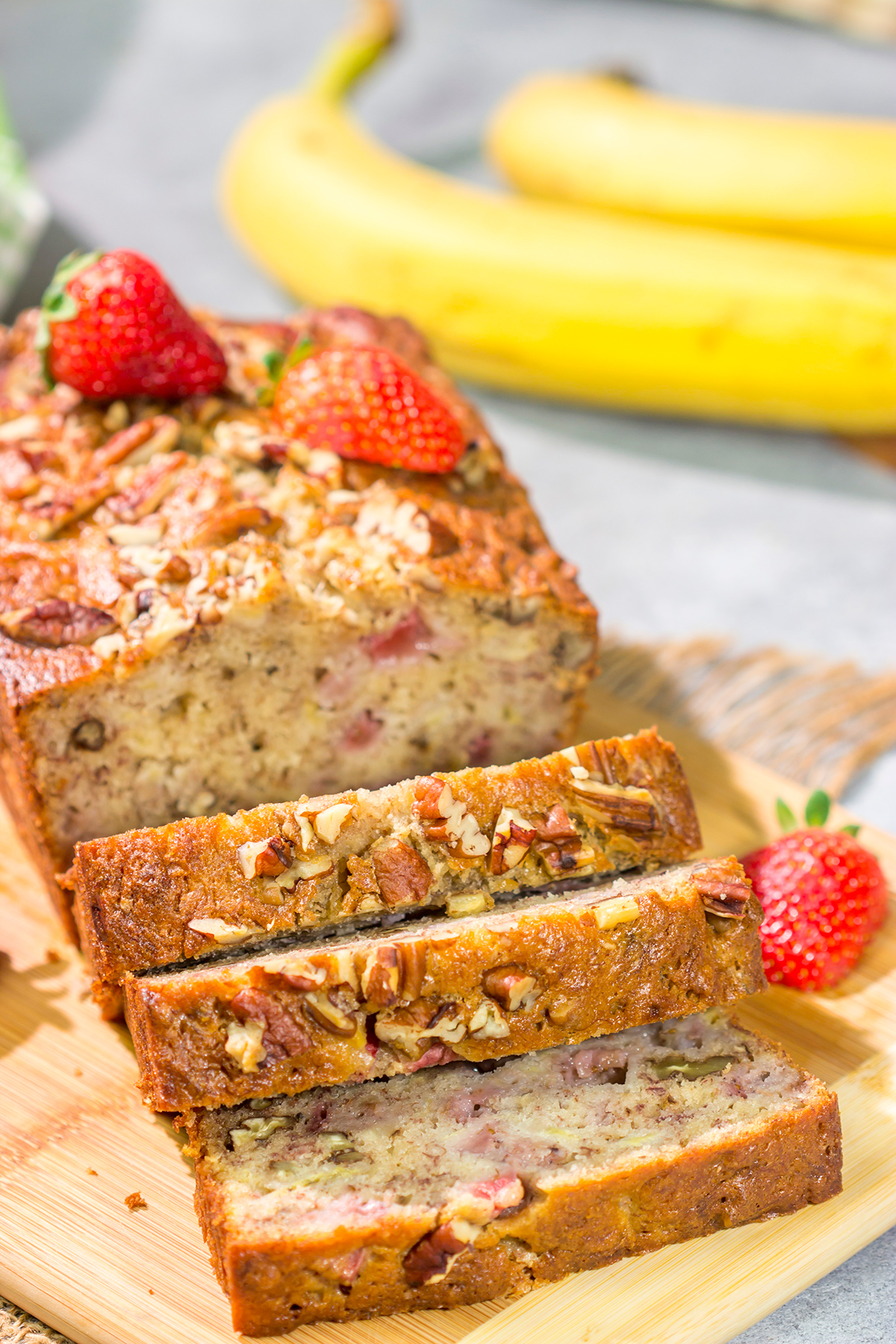 This Strawberry Banana Bread is packed with ripe banana + fresh strawberry flavor. A slice of this bread with a mug of hot coffee is a pretty fantastic way to start the day!
