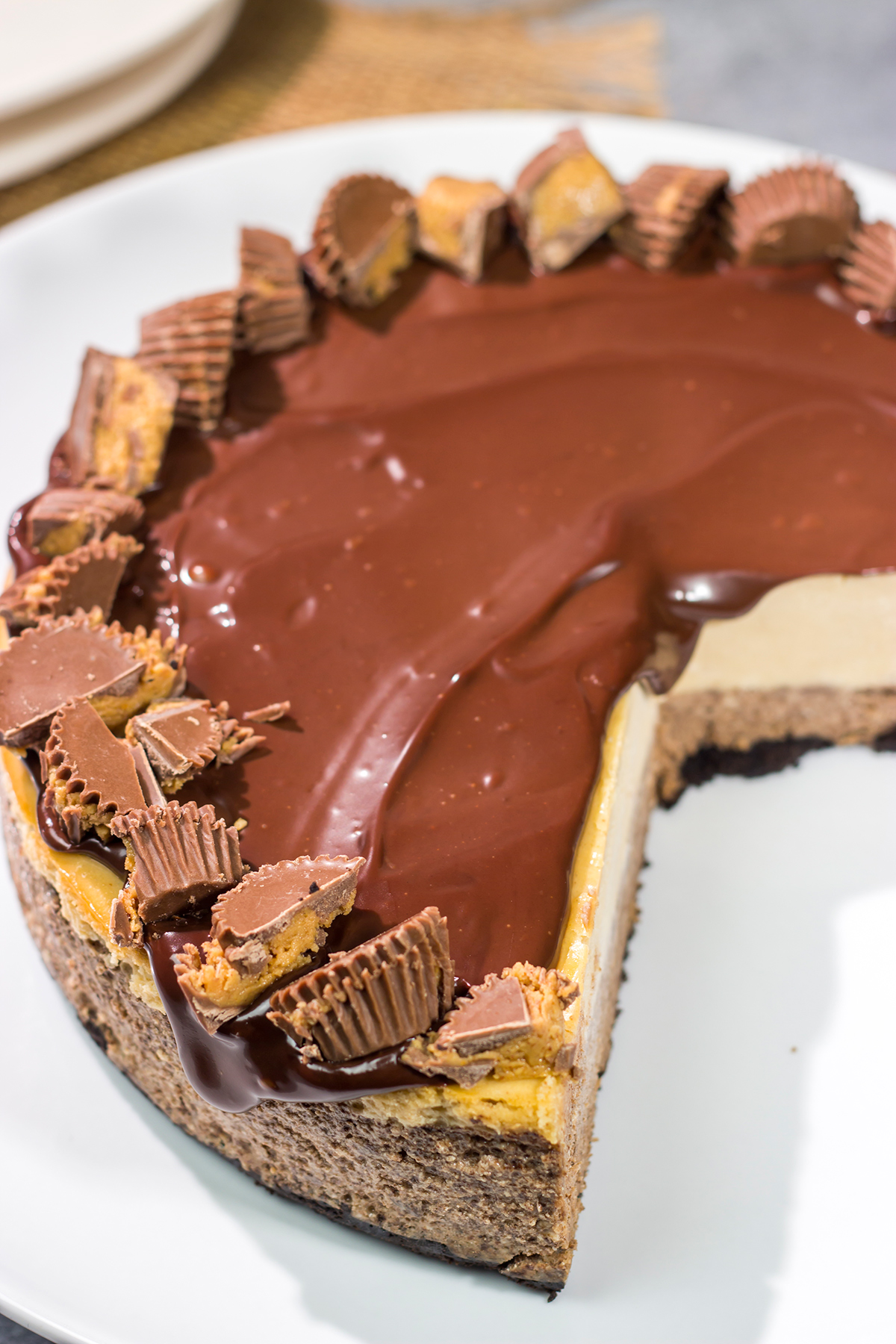 This Chocolate Peanut Butter Cheesecake features creamy layers of cheesecake topped with a decadent chocolate ganache. It's the ultimate chocolate lover's dessert!