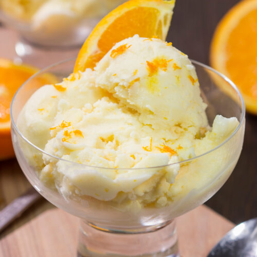 A bowl of this Homemade Orange Sherbet is creamy and refreshing - it's the perfect sweet treat for a warm summer day!