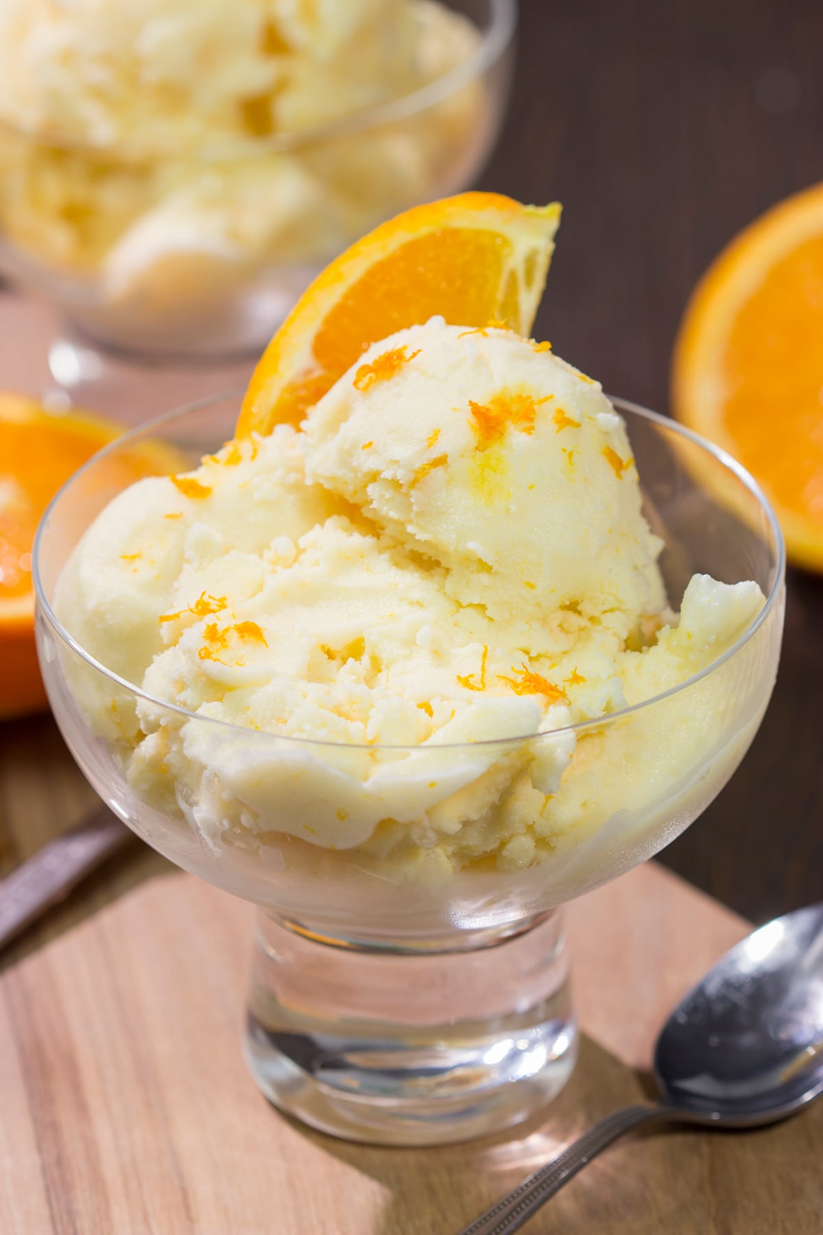 A bowl of this Homemade Orange Sherbet is creamy and refreshing - it's the perfect sweet treat for a warm summer day!