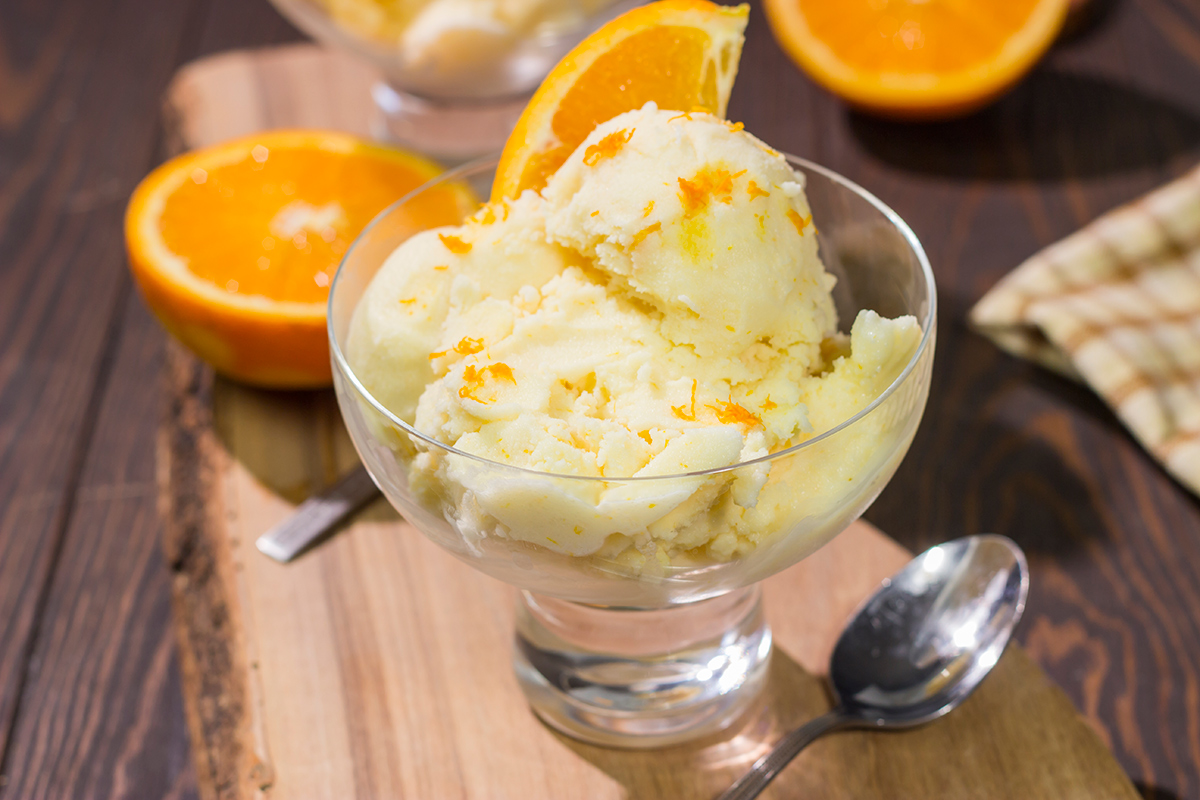 A bowl of this Homemade Orange Sherbet is creamy and refreshing - it's the perfect sweet treat for a warm summer day!