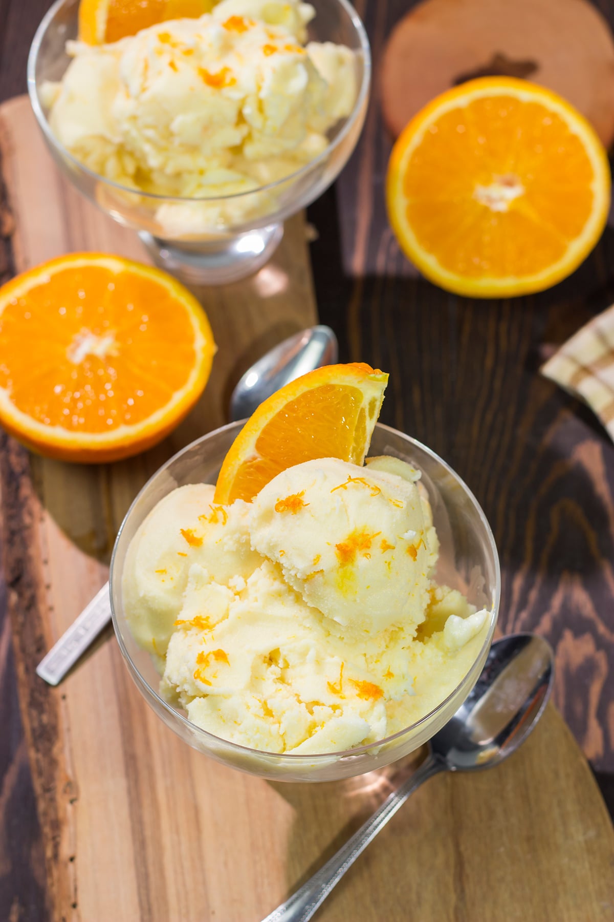 A bowl of this Homemade Orange Sherbet is creamy and refreshing - it's the perfect sweet treat for a warm summer day!