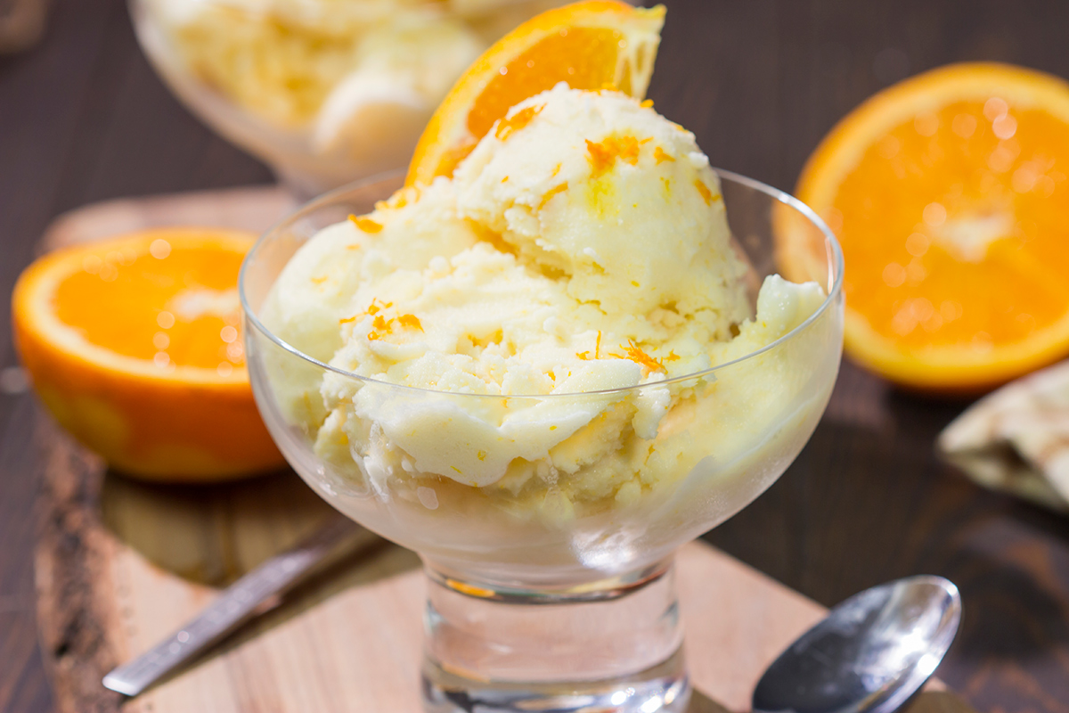 A bowl of this Homemade Orange Sherbet is creamy and refreshing - it's the perfect sweet treat for a warm summer day!