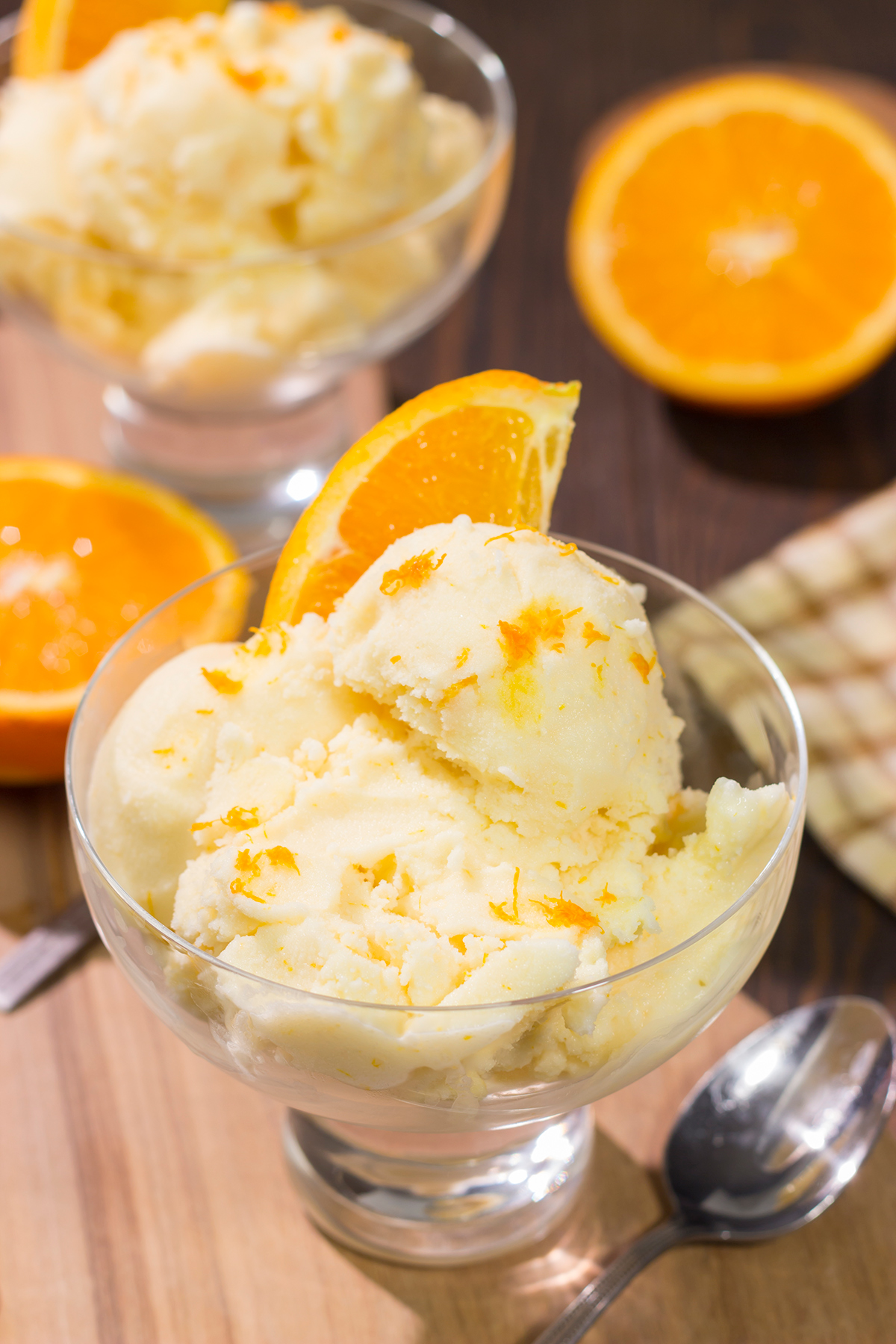 A bowl of this Homemade Orange Sherbet is creamy and refreshing - it's the perfect sweet treat for a warm summer day!