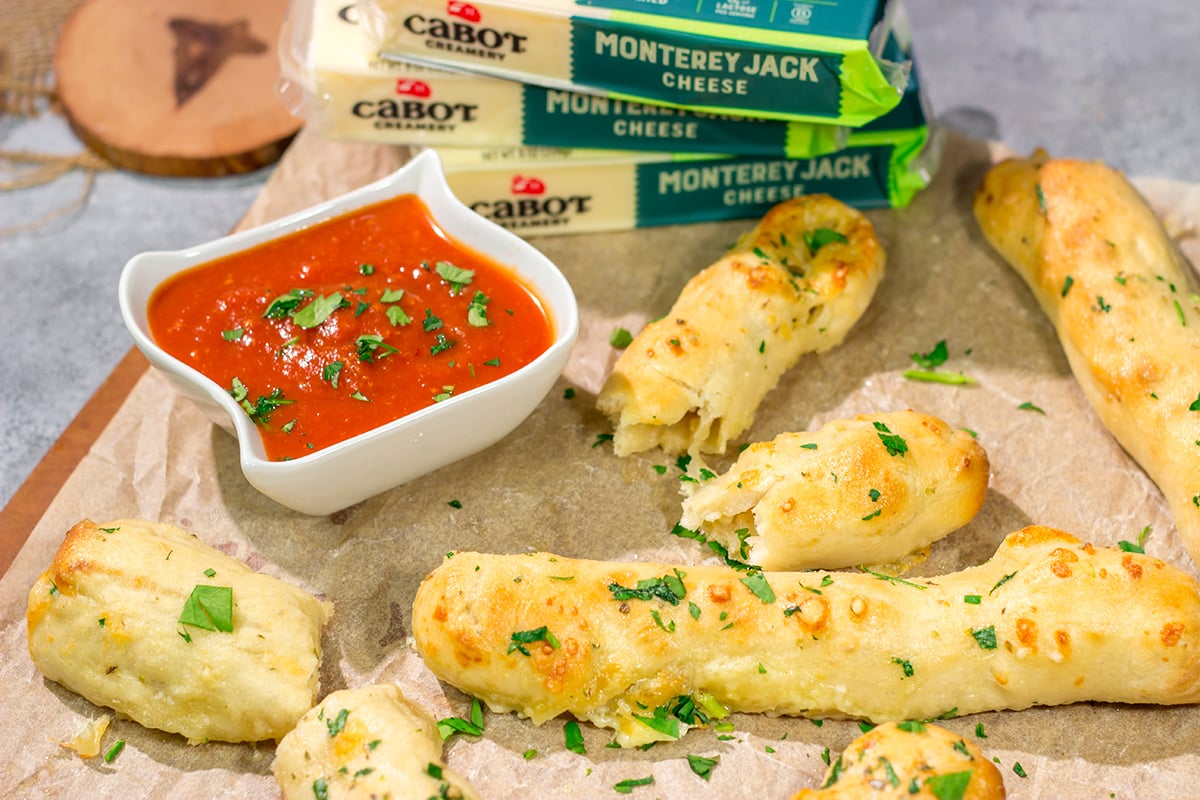 These Cheesy Stuffed Breadsticks are golden brown, buttery and stuffed with melted cheese - they're the ultimate comfort food appetizer or snack!