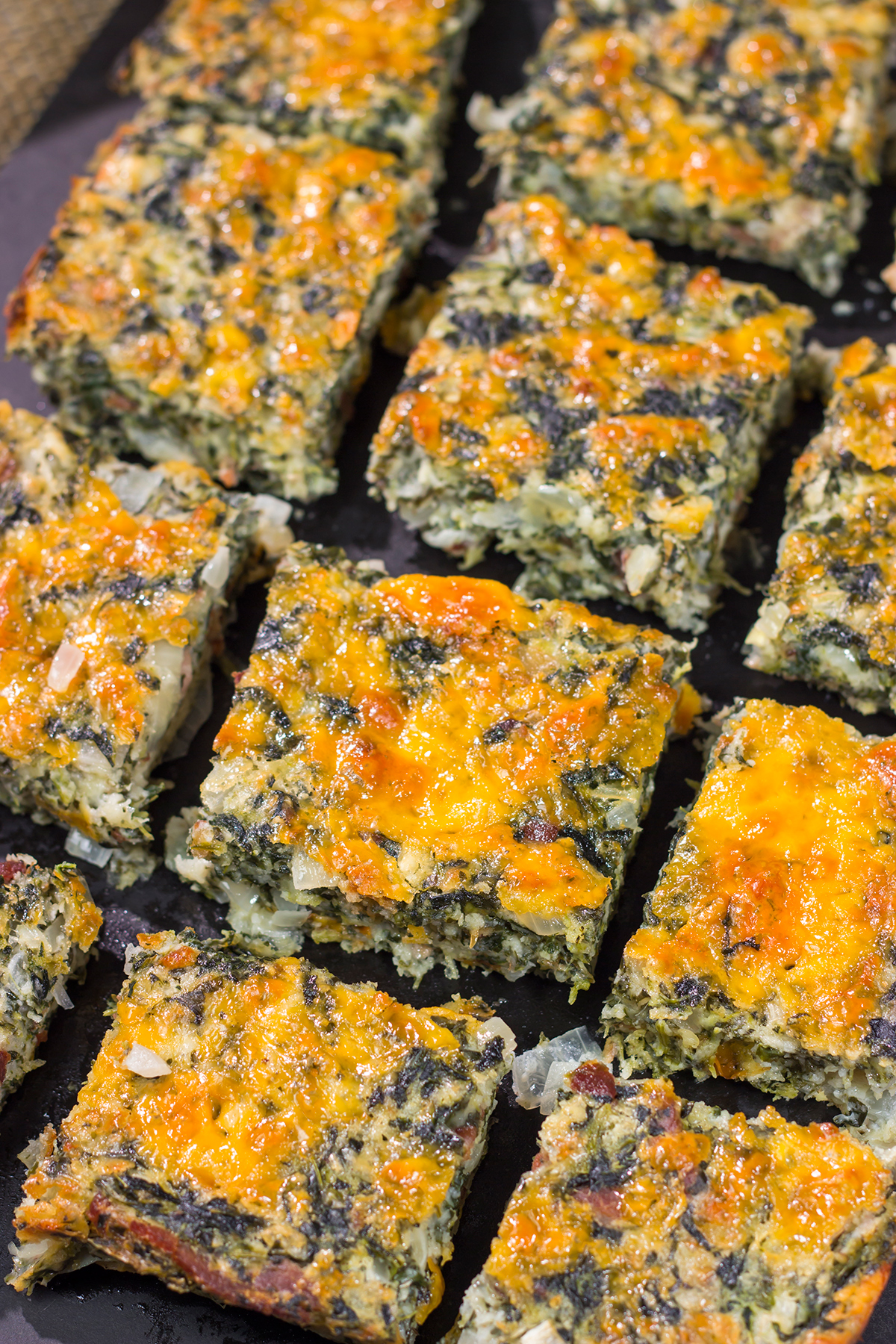These baked Bacon Cheddar Spinach Squares are packed with flavor! They're easy to make, and they're perfect as a side dish or party appetizer.
