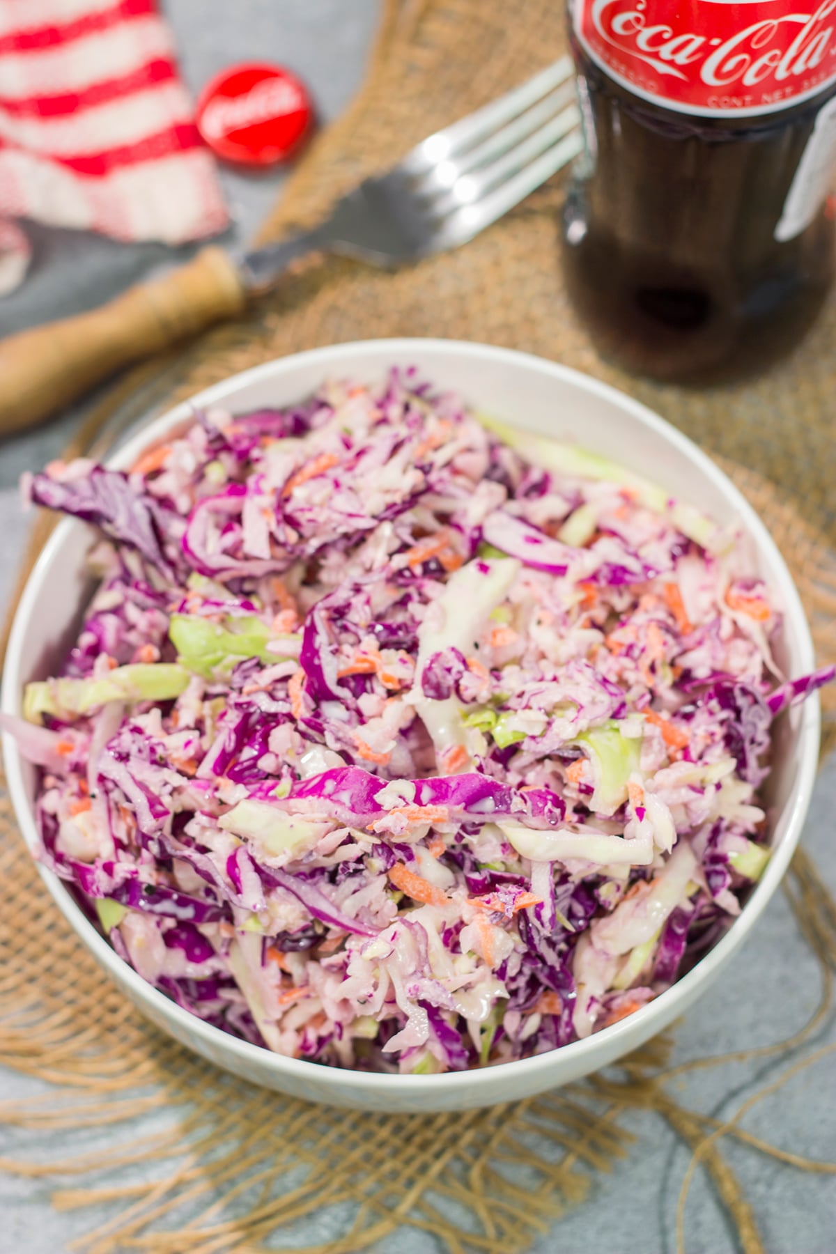 Add a fun twist to a classic coleslaw recipe with this Coca Cola Coleslaw. This classic slaw is flavorful and easy to make. It's perfect for summer picnics and BBQs!