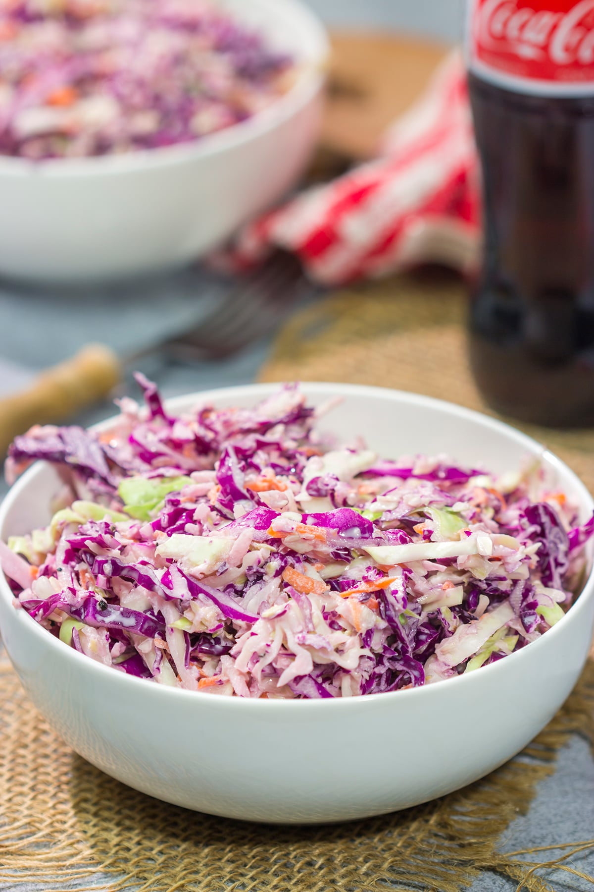 Add a fun twist to a classic coleslaw recipe with this Coca Cola Coleslaw. This classic slaw is flavorful and easy to make. It's perfect for summer picnics and BBQs!