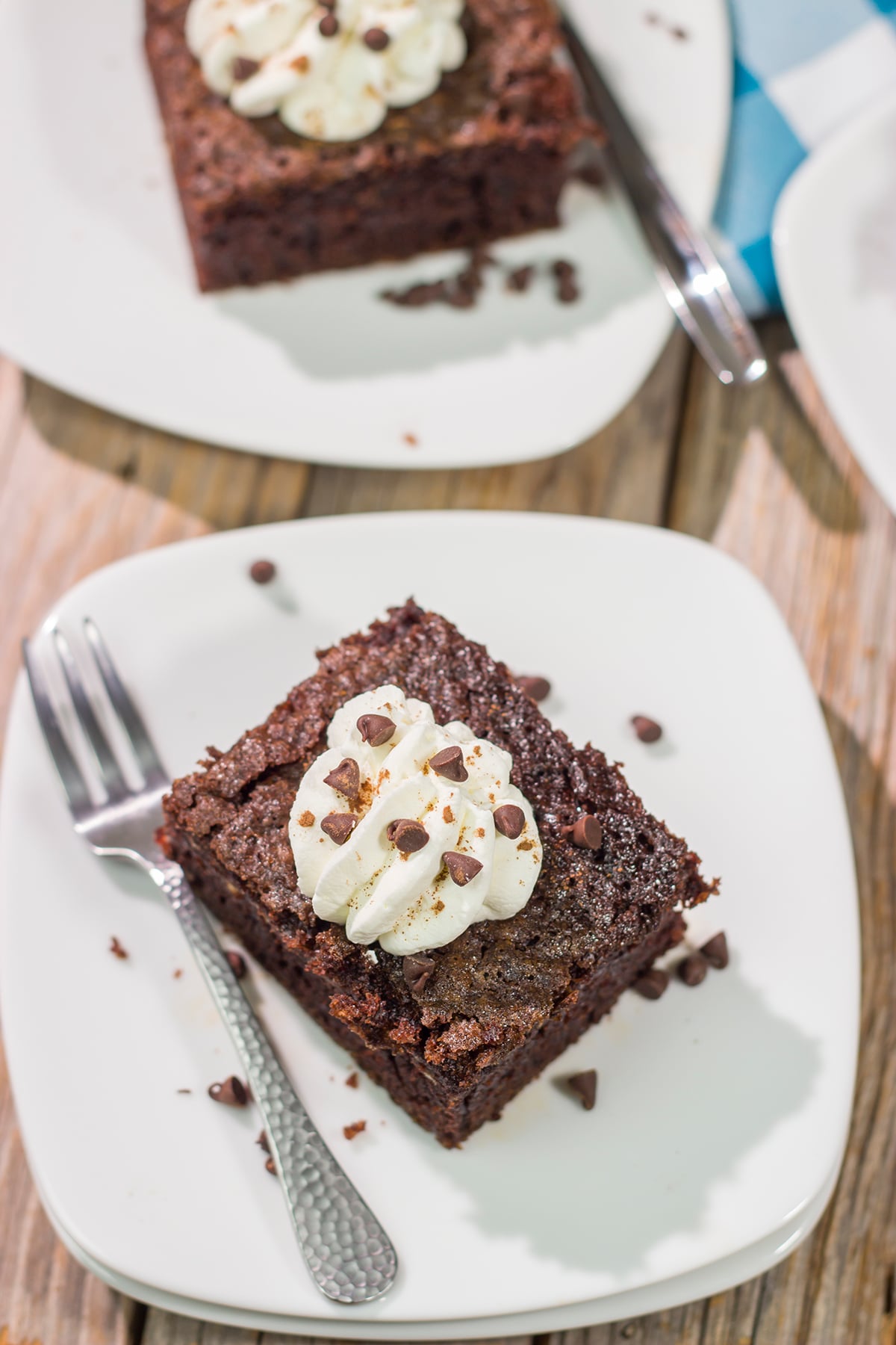 Hot summer day? Skip the oven and bake this Grilled Chocolate Cake on the grill instead! This cake is topped with whipped cream to create a tasty summer dessert.
