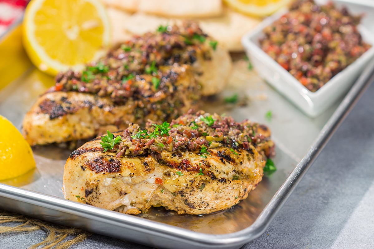 This Grilled Greek Chicken is tender and juicy...and packed with Mediterranean flavor! This easy recipe is perfect for summer grilling.