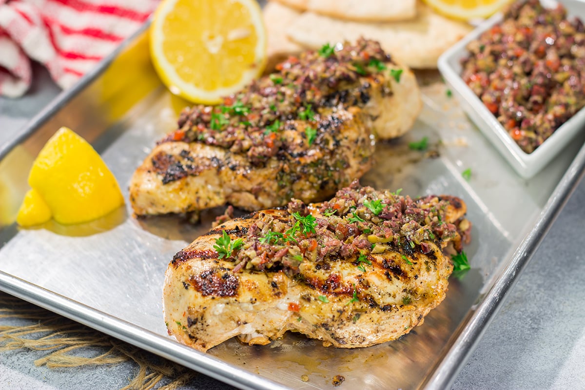 This Grilled Greek Chicken is tender and juicy...and packed with Mediterranean flavor! This easy recipe is perfect for summer grilling.