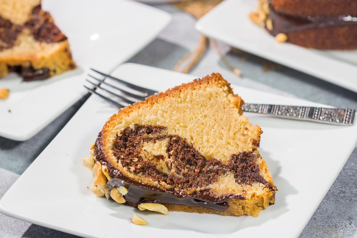 Featuring swirls of chocolate and peanut butter cake, this Chocolate Peanut Butter Pound Cake makes for a fun (and delicious) dessert recipe!