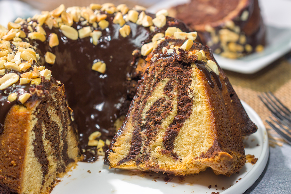 Featuring swirls of chocolate and peanut butter cake, this Chocolate Peanut Butter Pound Cake makes for a fun (and delicious) dessert recipe!