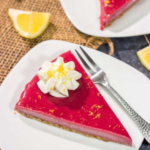 Featuring a sweet + tart raspberry filling over a graham cracker crust, this Frozen Raspberry Lemonade Tart is a tasty dessert for a warm summer evening!