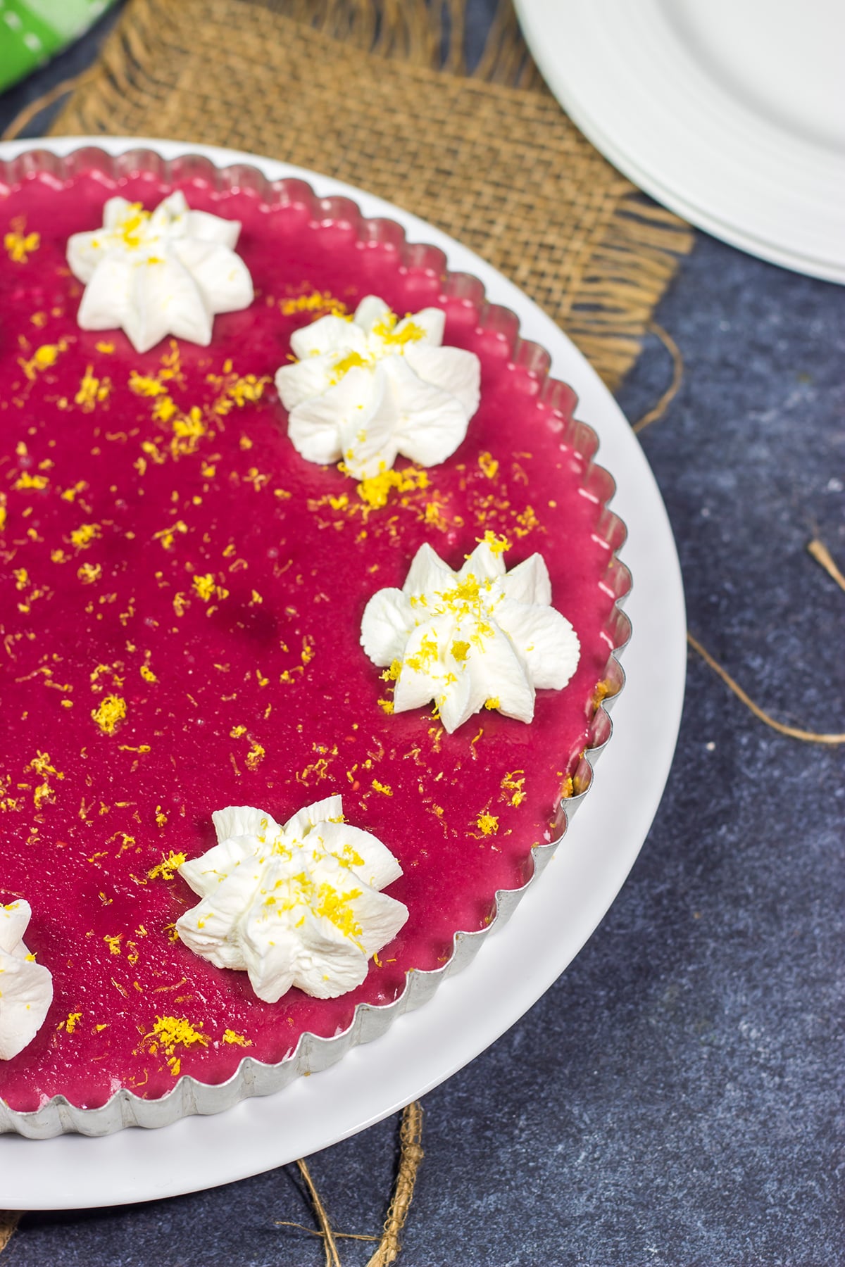 Featuring a sweet + tart raspberry filling over a graham cracker crust, this Frozen Raspberry Lemonade Tart is a tasty dessert for a warm summer evening!