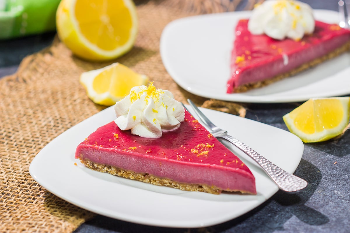 Featuring a sweet + tart raspberry filling over a graham cracker crust, this Frozen Raspberry Lemonade Tart is a tasty dessert for a warm summer evening!
