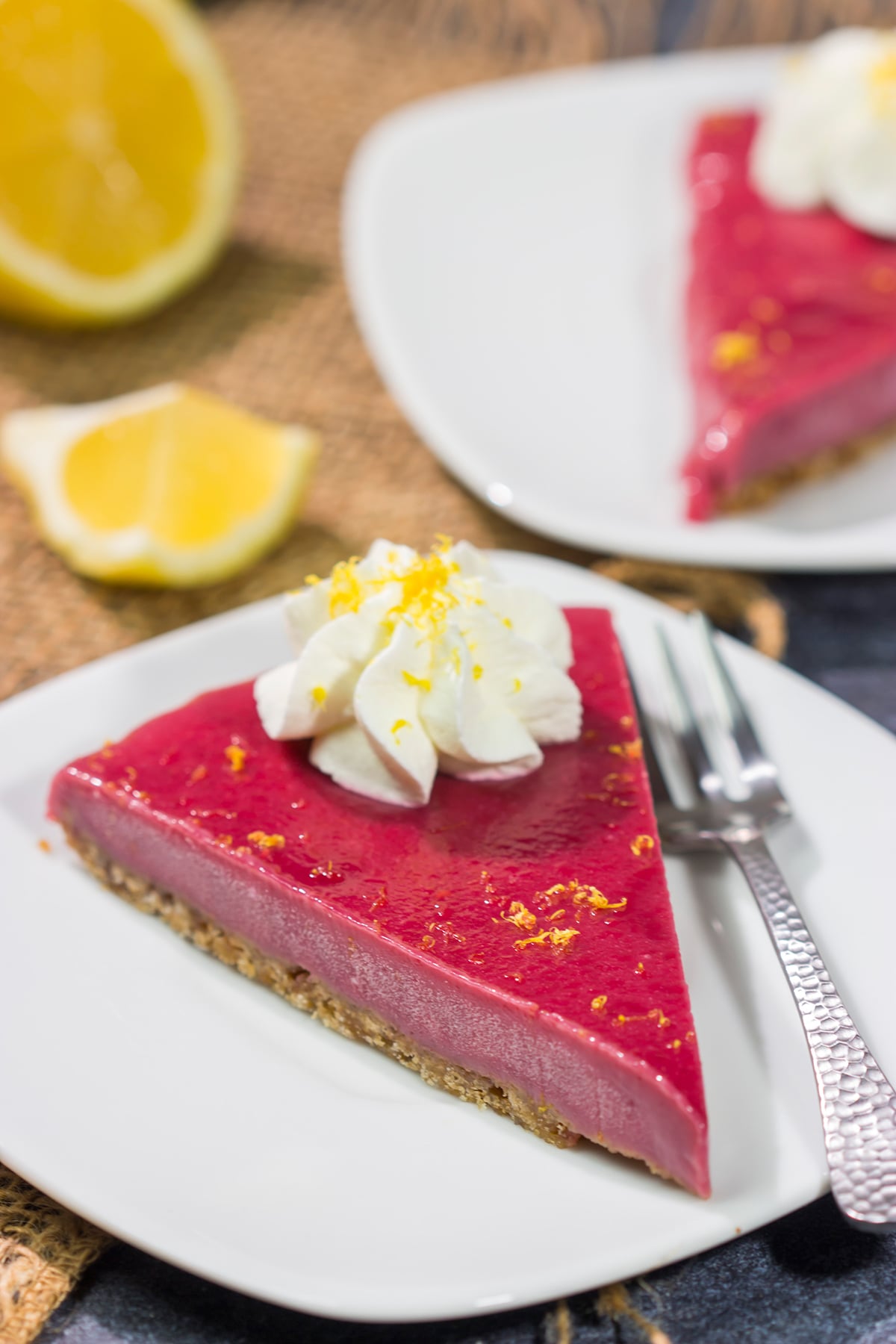 Featuring a sweet + tart raspberry filling over a graham cracker crust, this Frozen Raspberry Lemonade Tart is a tasty dessert for a warm summer evening!