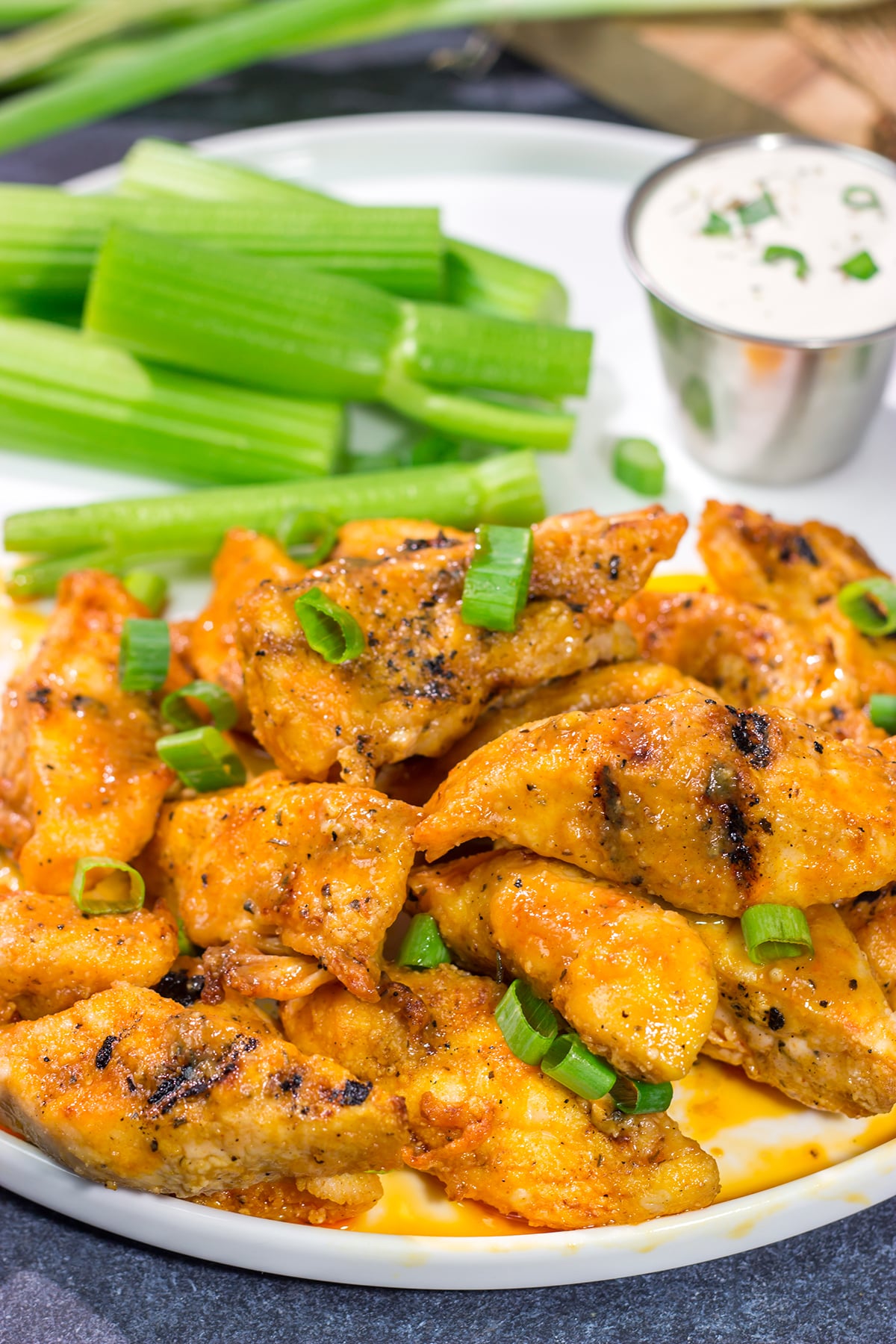 Fire up the grill! Tossed in a homemade buffalo sauce, these Grilled Boneless Buffalo Wings are a fun recipe for summer!