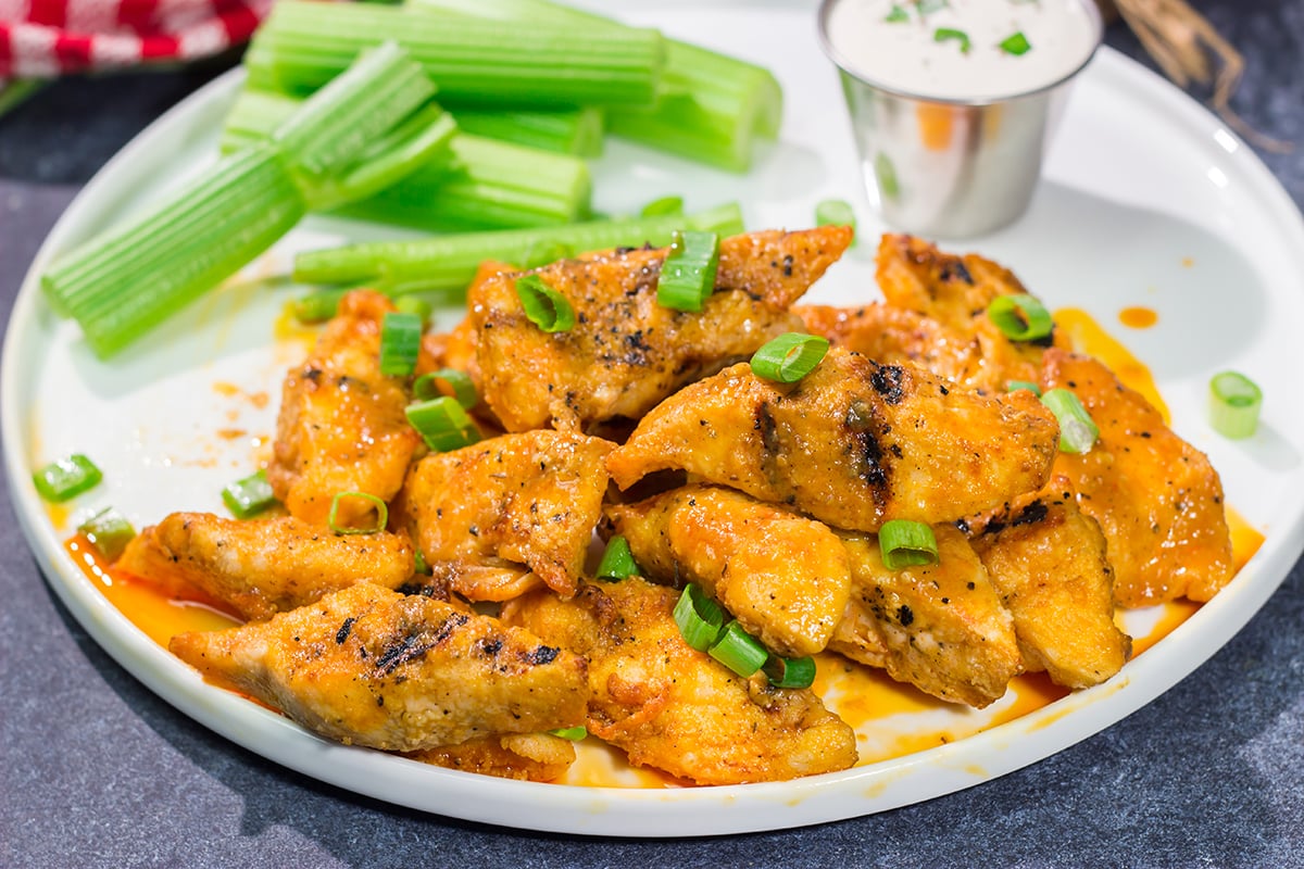 Fire up the grill! Tossed in a homemade buffalo sauce, these Grilled Boneless Buffalo Wings are a fun recipe for summer!
