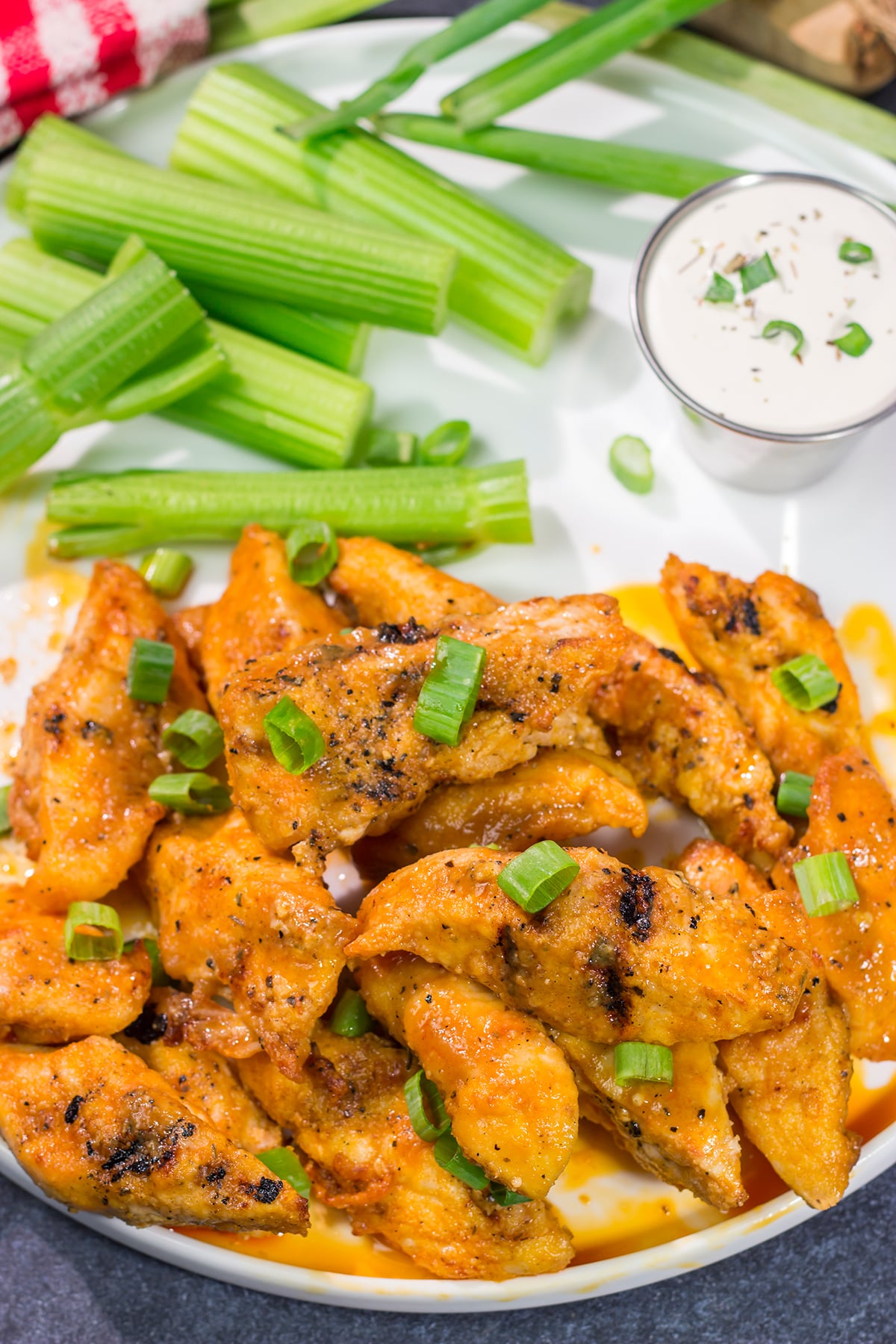 Fire up the grill! Tossed in a homemade buffalo sauce, these Grilled Boneless Buffalo Wings are a fun recipe for summer!