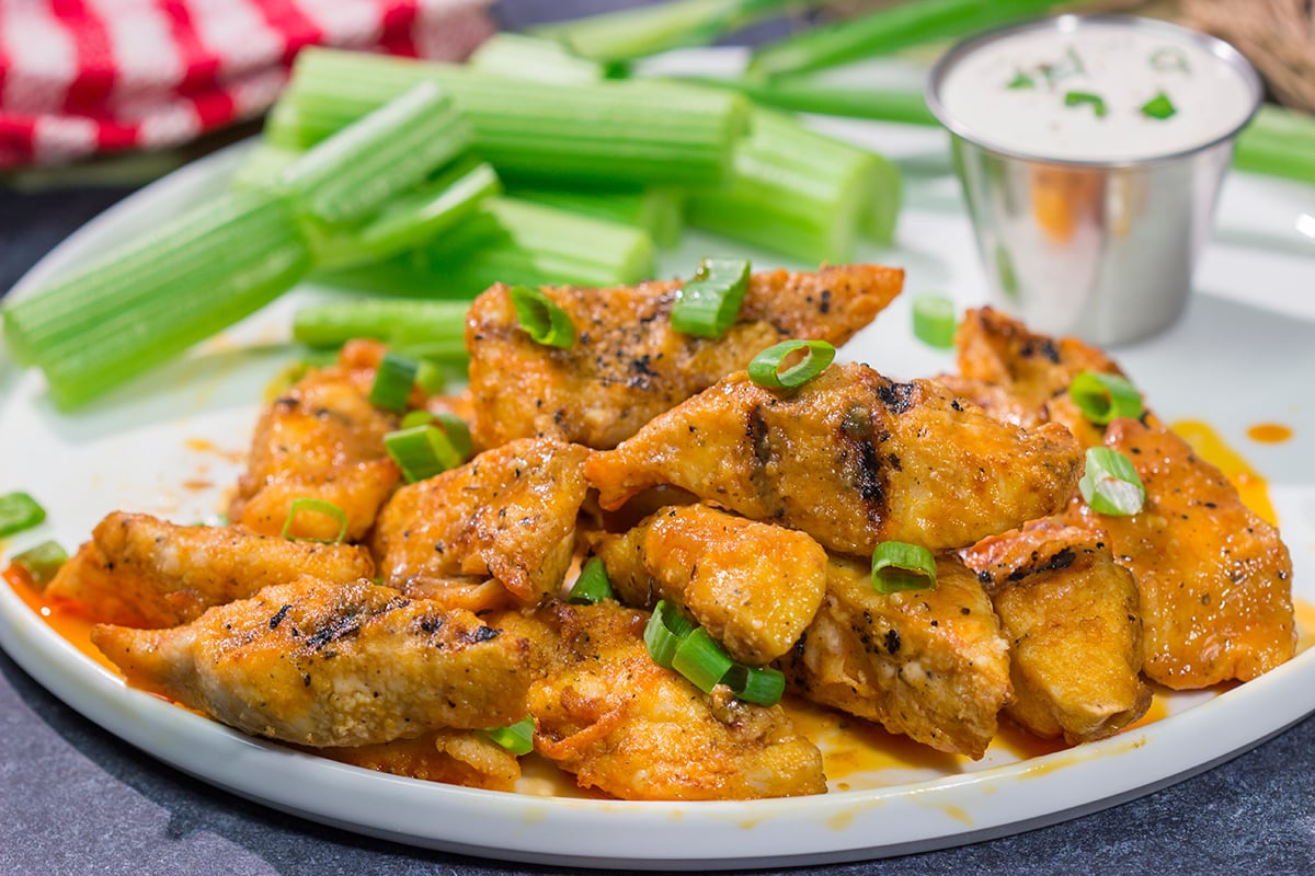 Fire up the grill! Tossed in a homemade buffalo sauce, these Grilled Boneless Buffalo Wings are a fun recipe for summer!