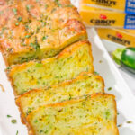This Cheesy Zucchini Bread is packed with summer flavor! Toast up a slice of this savory quick bread and serve it next to salad or soup for an easy meal.