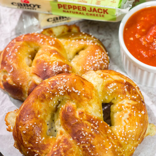 These Cheesy Soft Pretzels are stuffed with melty cheese for the ultimate gameday snack. These warm, golden brown pretzels are absolutely irresistible!