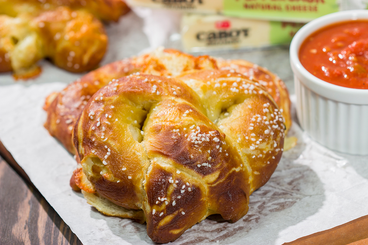 These Cheesy Soft Pretzels are stuffed with melty cheese for the ultimate gameday snack. These warm, golden brown pretzels are absolutely irresistible!
