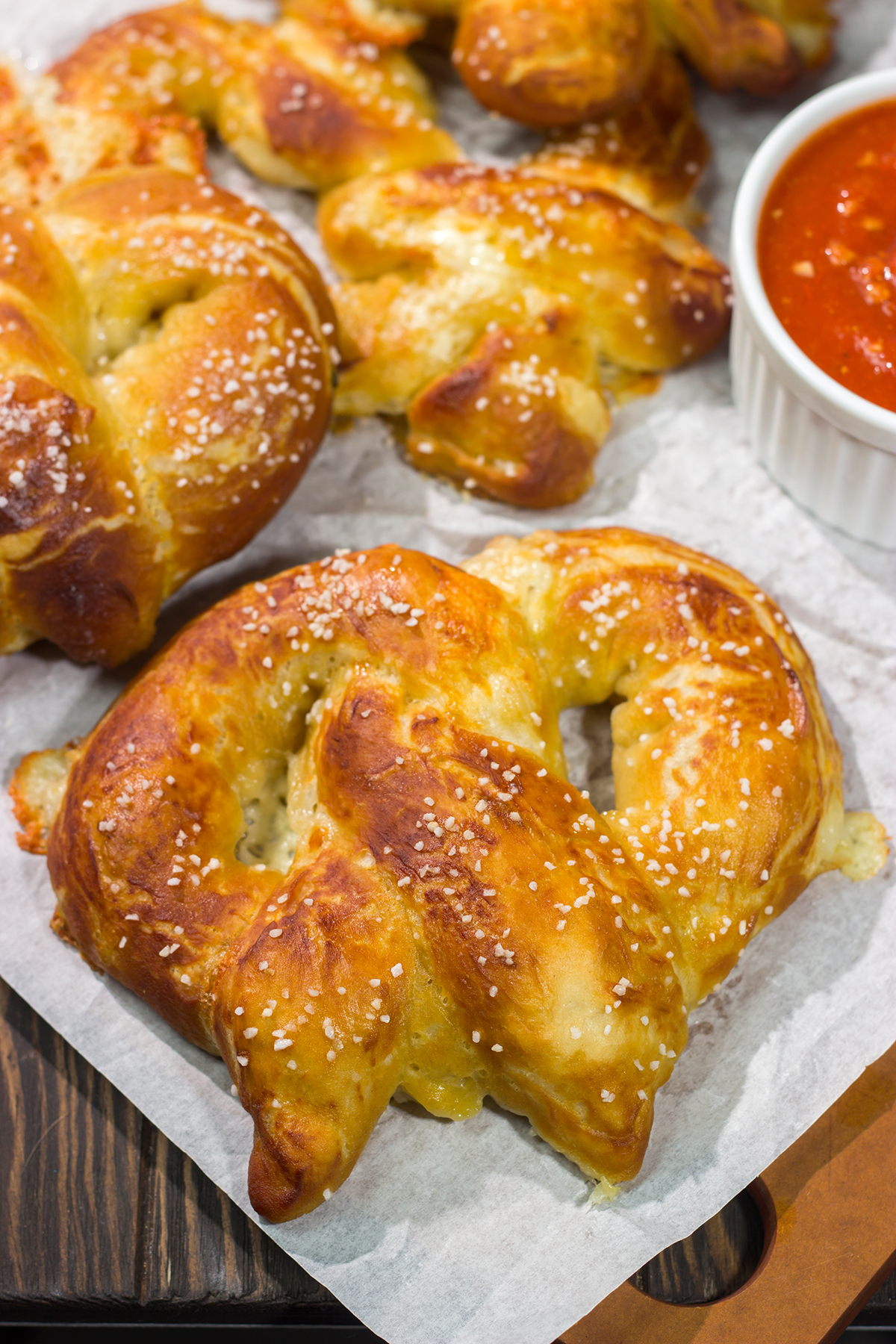These Cheesy Soft Pretzels are stuffed with melty cheese for the ultimate gameday snack. These warm, golden brown pretzels are absolutely irresistible!