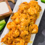 These Fried Buffalo Shrimp are the perfect gameday appetizer! The crispy fried shrimp are tossed in homemade buffalo sauce for maximum flavor.