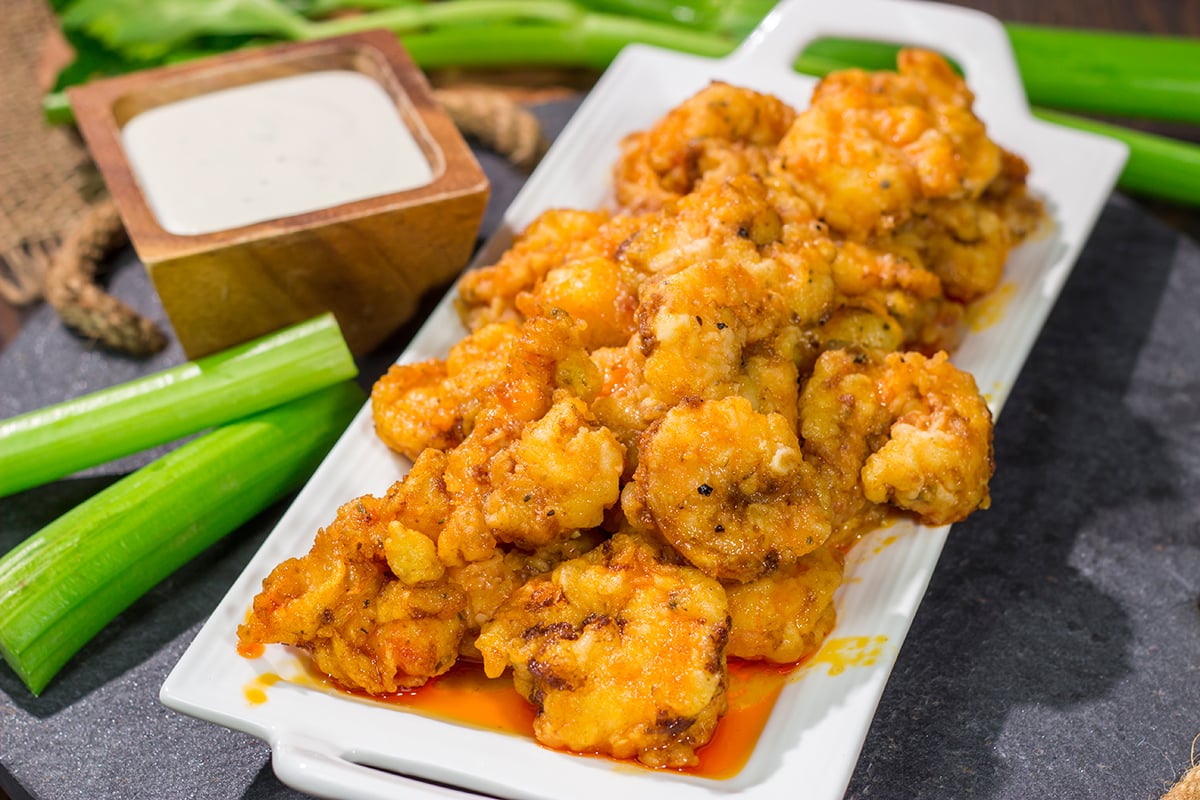 These Fried Buffalo Shrimp are the perfect gameday appetizer! The crispy fried shrimp are tossed in homemade buffalo sauce for maximum flavor.