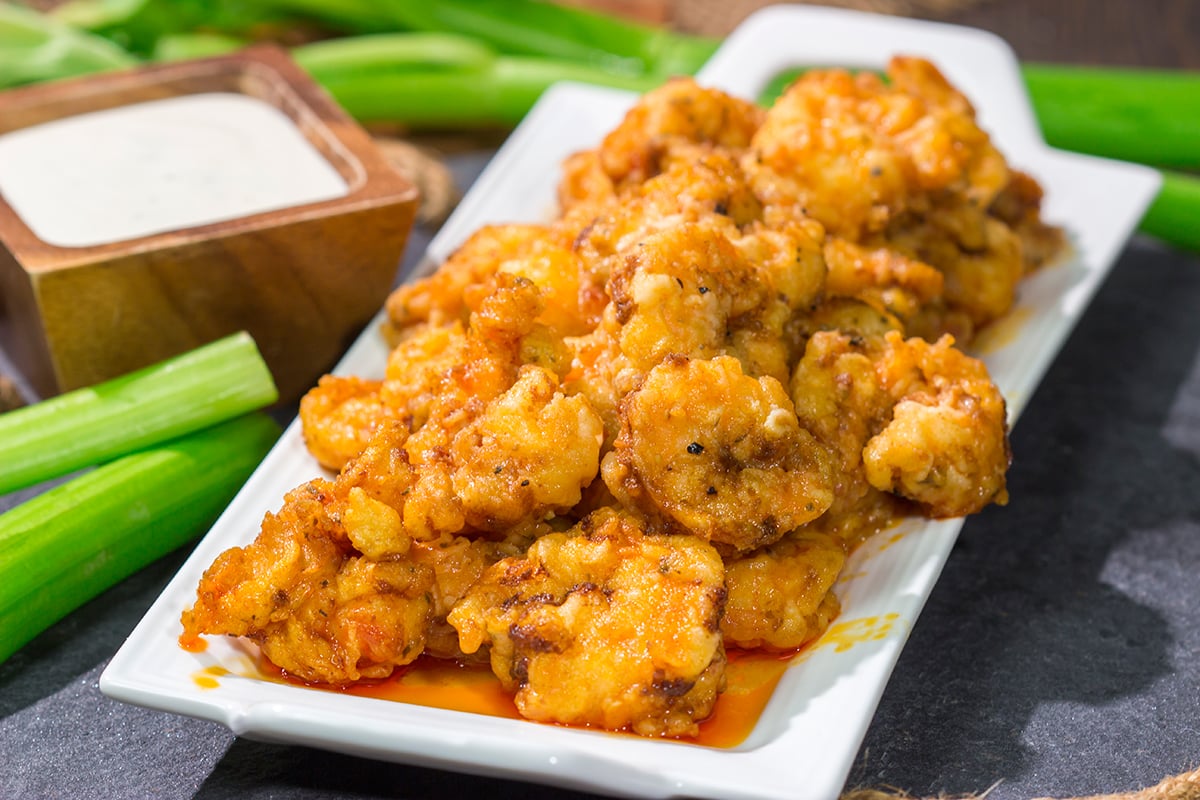 These Fried Buffalo Shrimp are the perfect gameday appetizer! The crispy fried shrimp are tossed in homemade buffalo sauce for maximum flavor.