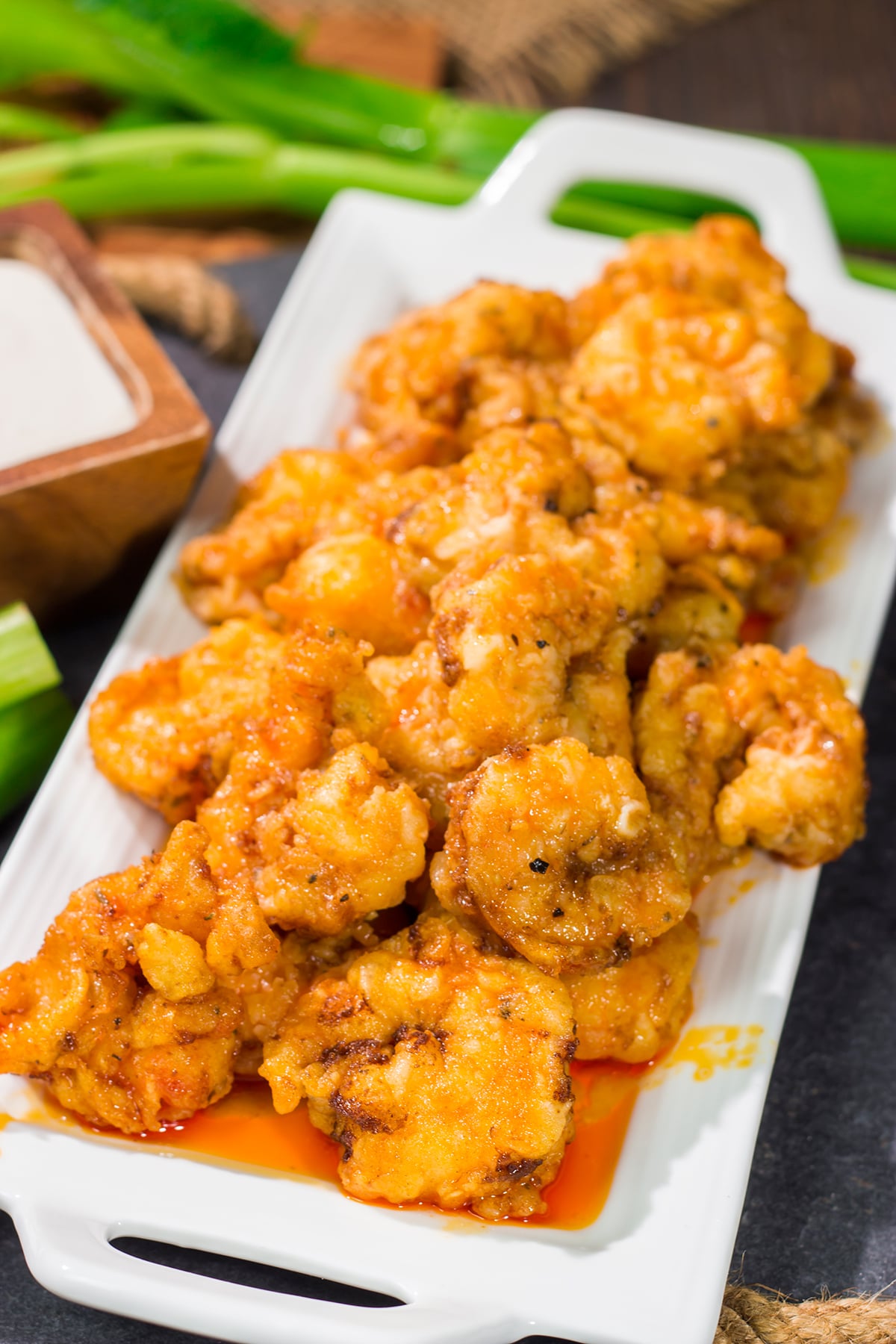 These Fried Buffalo Shrimp are the perfect gameday appetizer! The crispy fried shrimp are tossed in homemade buffalo sauce for maximum flavor.