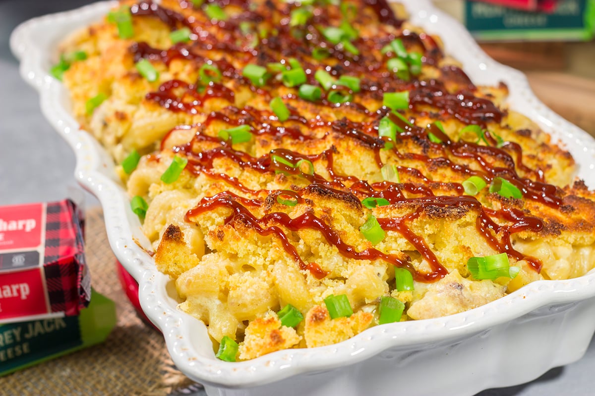This BBQ Mac & Cheese recipe combines multiple favorites into one! Creamy mac and cheese, tender pulled pork and crumbled cornbread all combine to create a delicious dish.