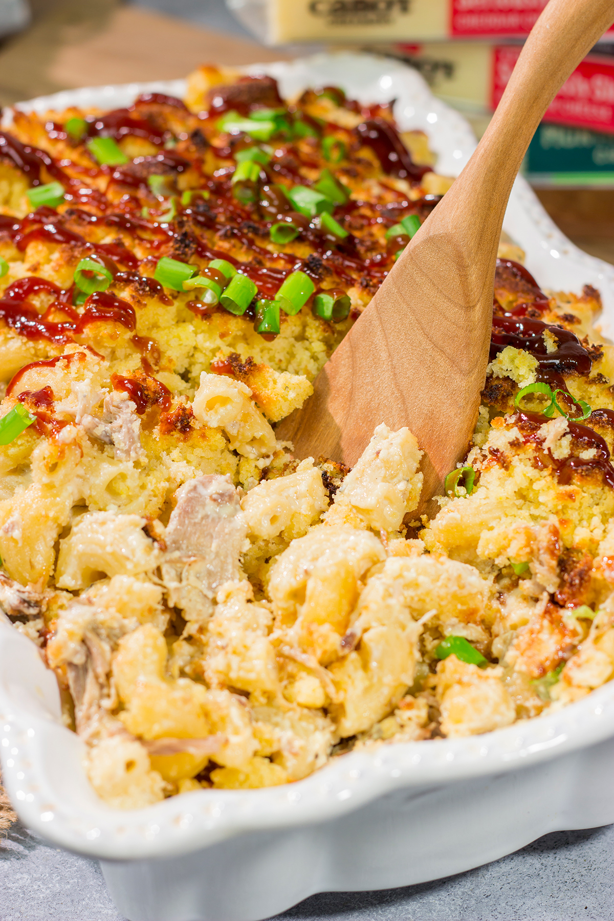 This BBQ Mac & Cheese recipe combines multiple favorites into one! Creamy mac and cheese, tender pulled pork and crumbled cornbread all combine to create a delicious dish.