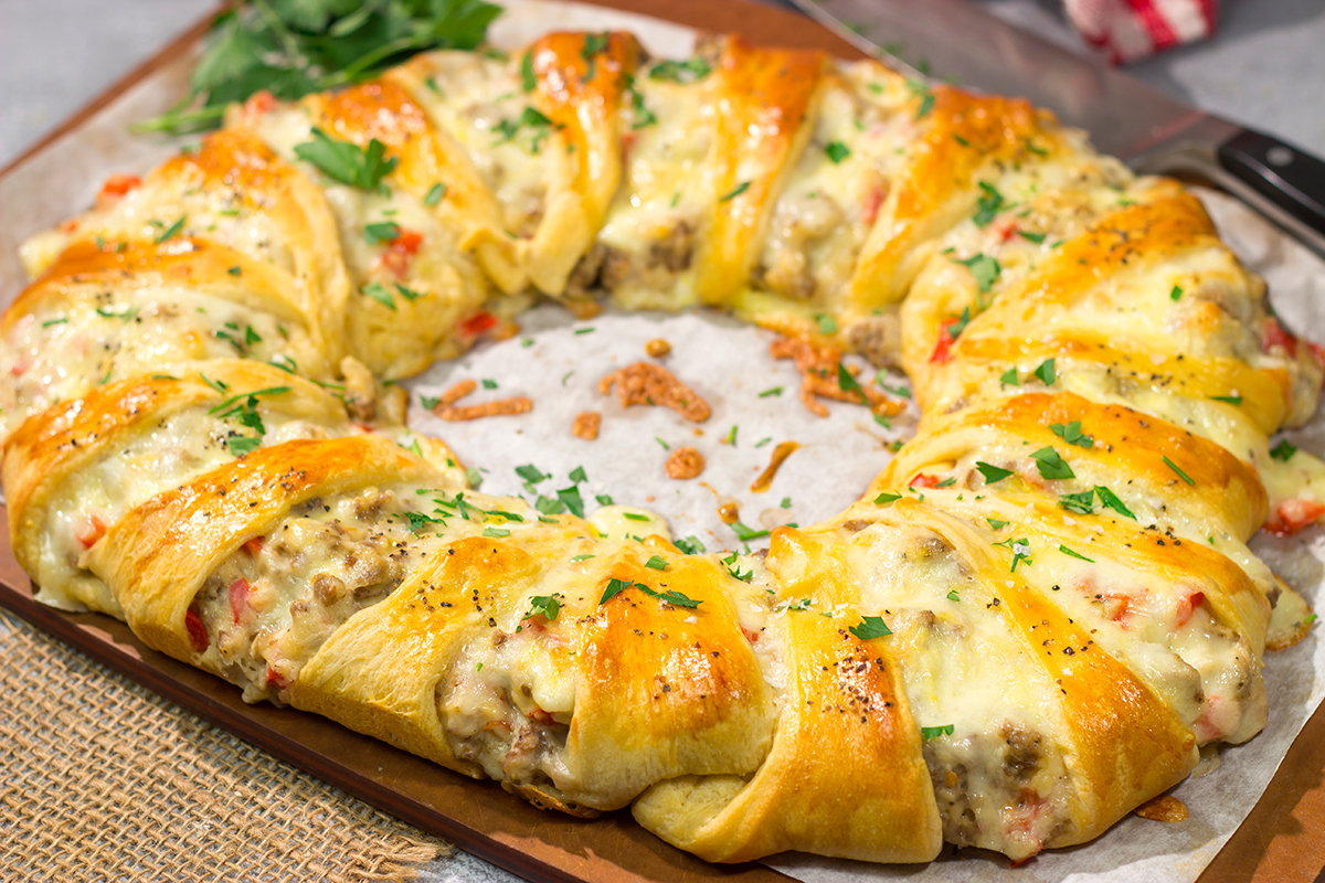 This Cheesy Sausage Wreath features creamy sausage gravy wrapped in golden brown dough. It makes for an excellent holiday breakfast or brunch when guests are in town!