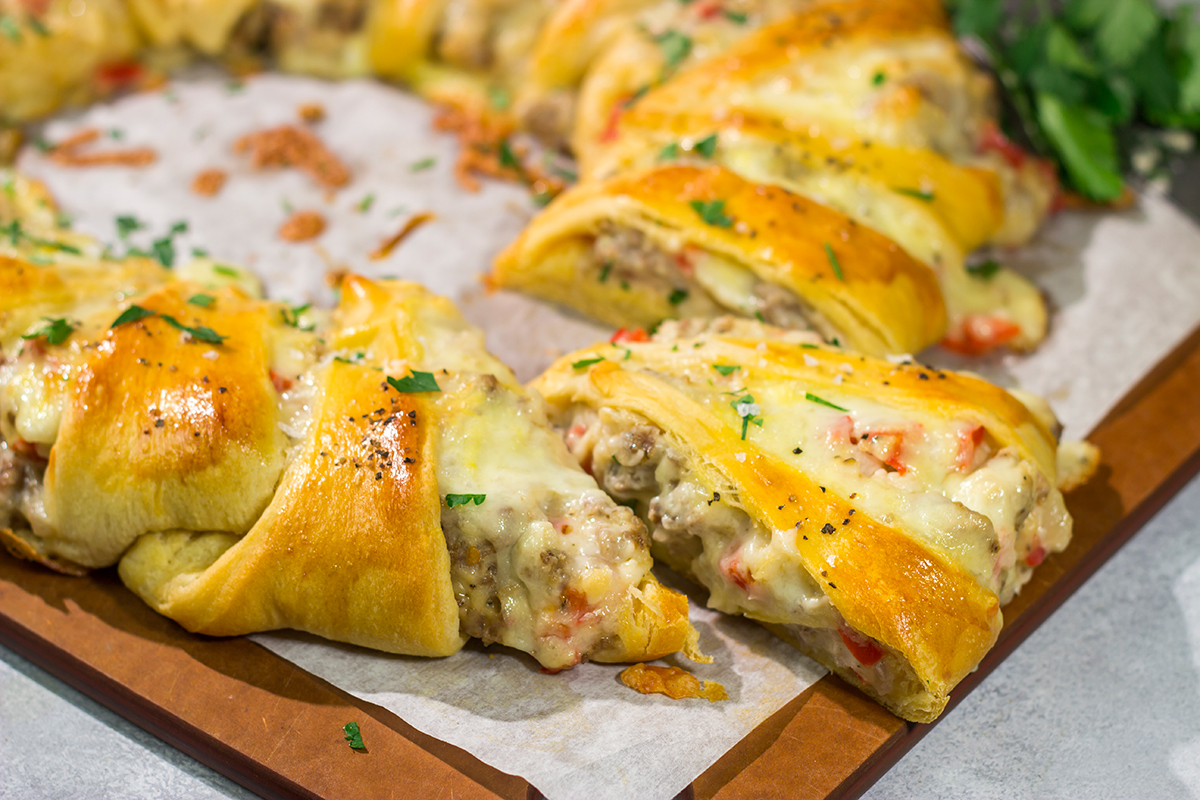 This Cheesy Sausage Wreath features creamy sausage gravy wrapped in golden brown dough. It makes for an excellent holiday breakfast or brunch when guests are in town!