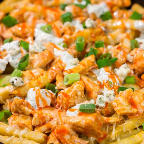 These Buffalo Chicken Cheese Fries are a fantastic gameday appetizer! The kick from the buffalo chicken combined with the creamy blue cheese dressing and melted cheese is a mouthwatering combo.
