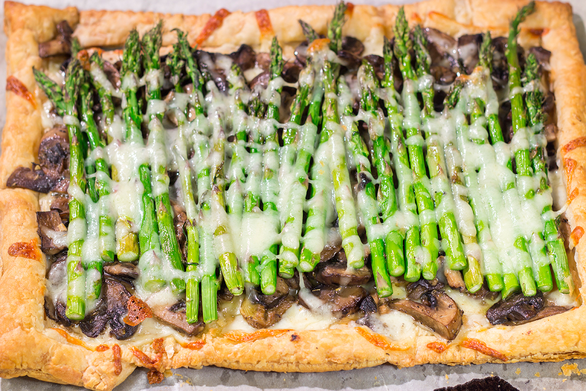 This Cheesy Mushroom Asparagus Tart features flaky puff pastry piled with savory mushrooms, tender asparagus and plenty of melted cheese. It's an easy yet elegant recipe that's perfect for an appetizer or side dish!