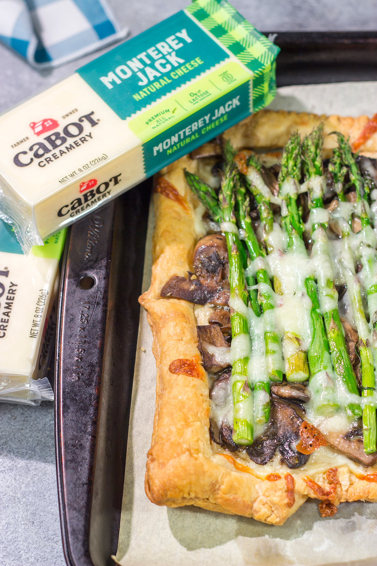 This Cheesy Mushroom Asparagus Tart features flaky puff pastry piled with savory mushrooms, tender asparagus and plenty of melted cheese. It's an easy yet elegant recipe that's perfect for an appetizer or side dish!